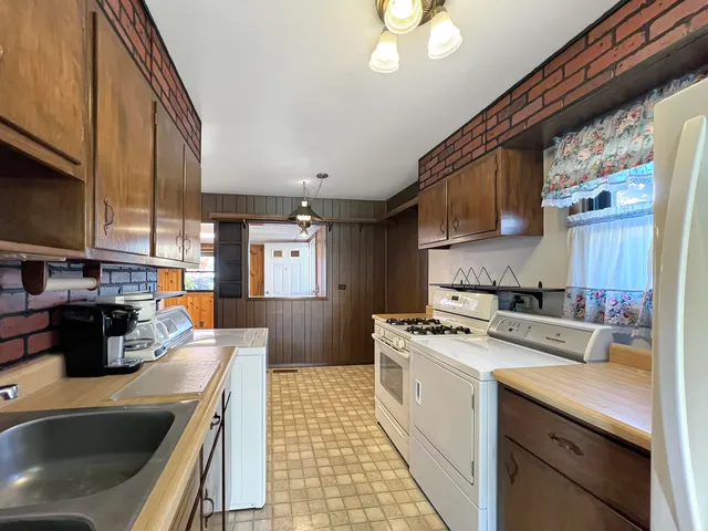 a kitchen with stainless steel appliances granite countertop a stove a refrigerator and a microwave