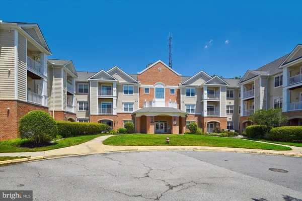 a view of a brick house with a yard next to a yard