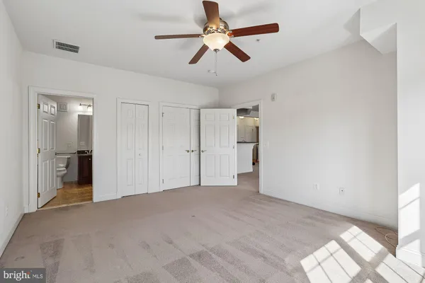 a view of empty room with ceiling fan