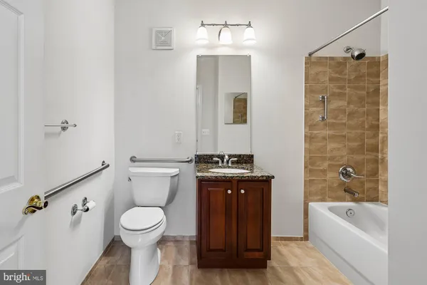a bathroom with a toilet a sink and bathtub