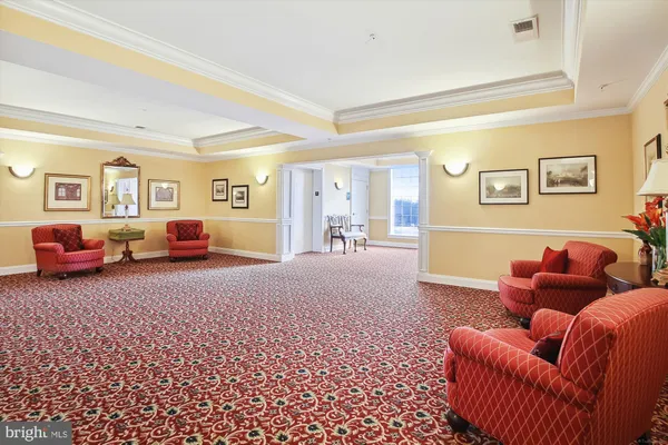 a living room with furniture and a mirror