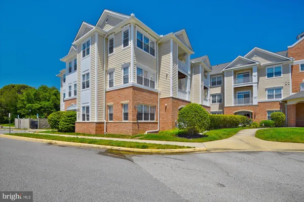 a view of a white building among the street side houses