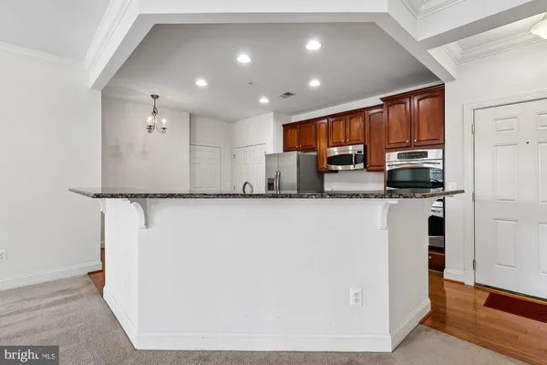 a kitchen with stainless steel appliances granite countertop a refrigerator sink and cabinets