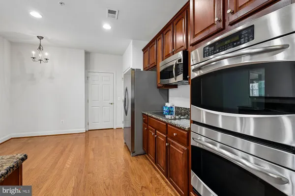 a kitchen with stainless steel appliances granite countertop a stove and a refrigerator
