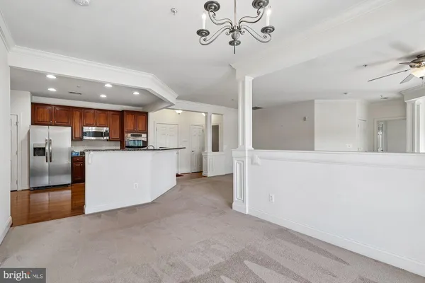 a view of a kitchen with a refrigerator a sink a kitchen island