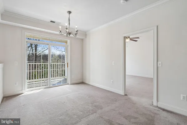 a view of a room with a ceiling fan and window