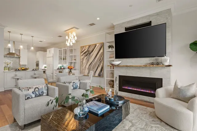 a living room with furniture a fireplace and a flat screen tv