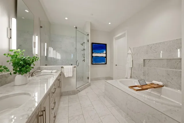 a bathroom with a tub sink and mirror