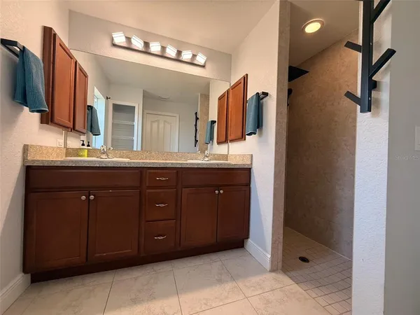 a bathroom with a double vanity sink and a mirror