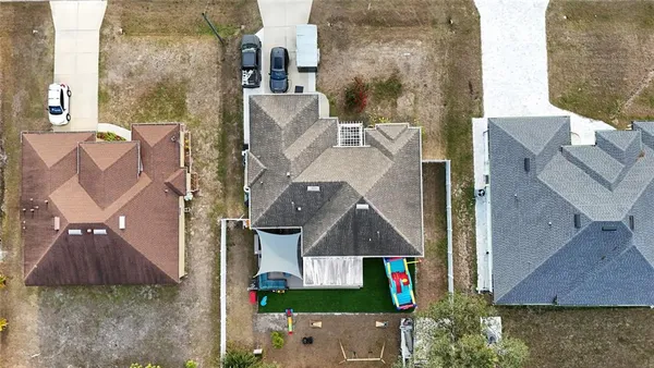 an aerial view of houses with yard