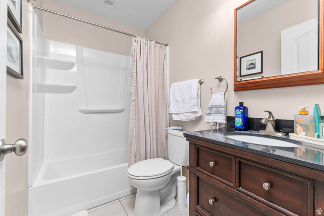 1489 North 400 West Bountiful, UT 84010 - Photo 20 of 47 Bathroom featuring a dark wood vanity with a built-in sink, dark countertop, and a wall-mounted mirror