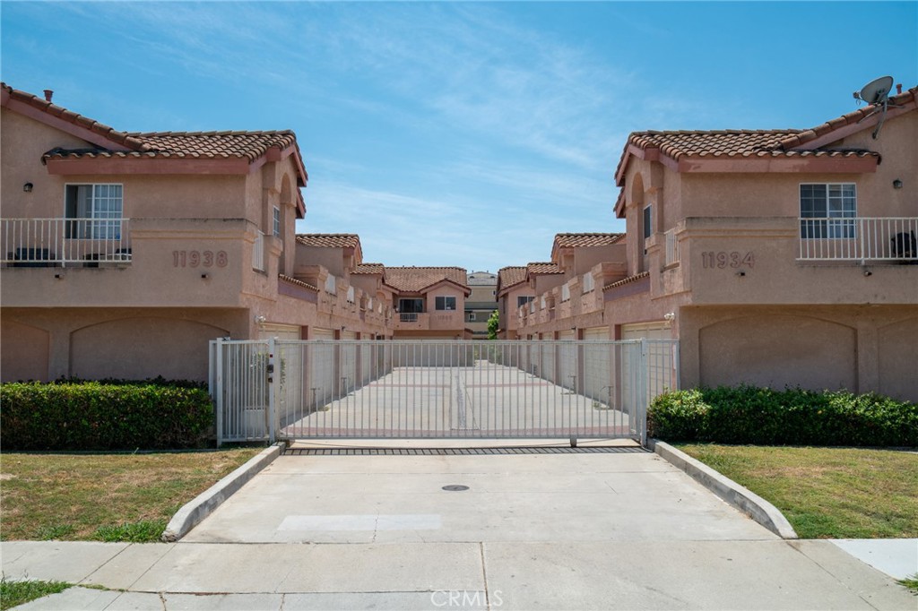 11932 207th Street Lakewood, CA 90715 - Photo 3 of 15 a view of a street with houses