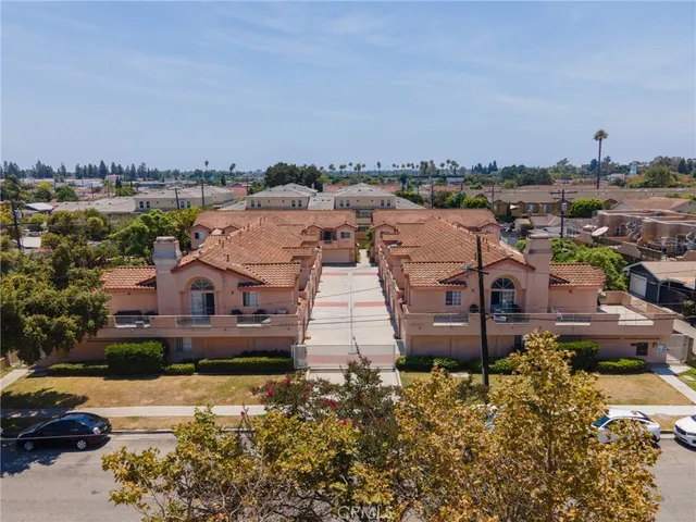 an aerial view of a house with a garden and lake view