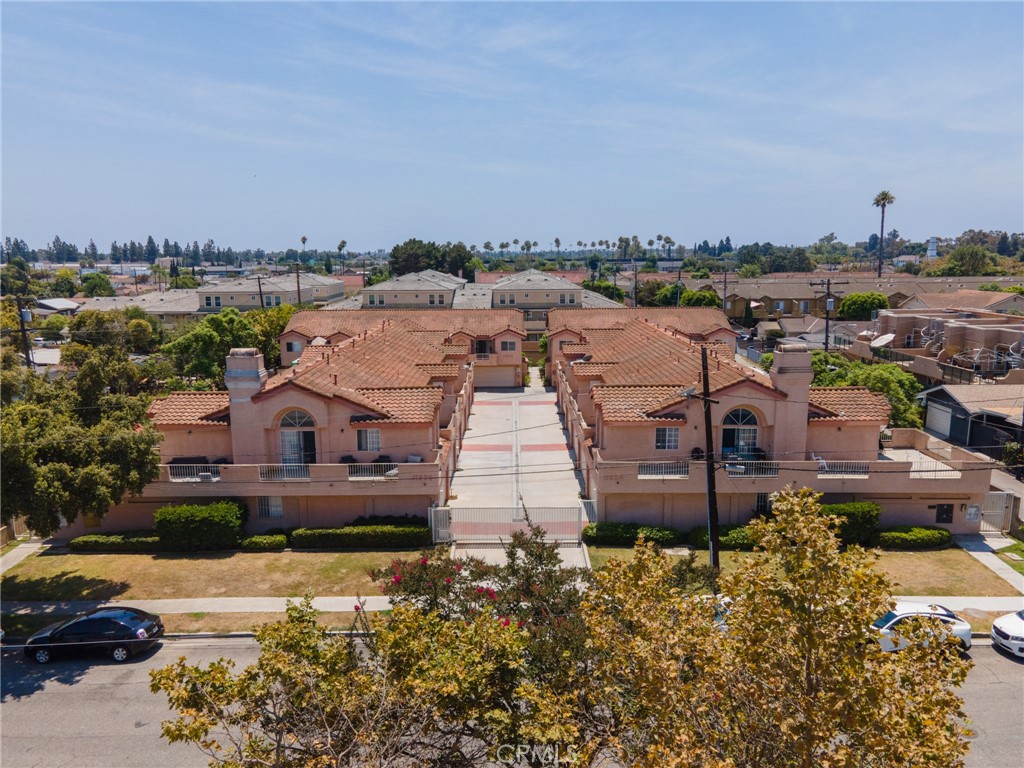 11932 207th Street Lakewood, CA 90715 - Photo 5 of 15 an aerial view of a house with a garden and lake view