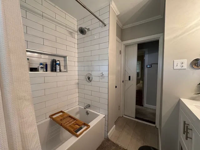 a bathroom with a sink a mirror and shower