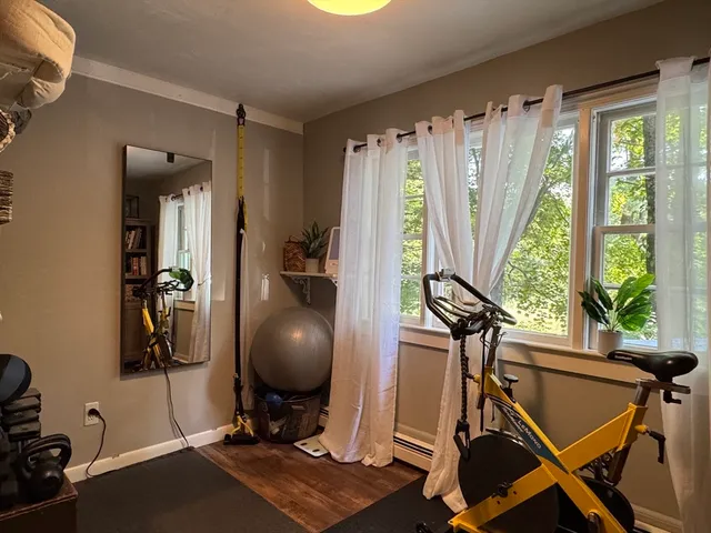 a view of a workspace with furniture and a window