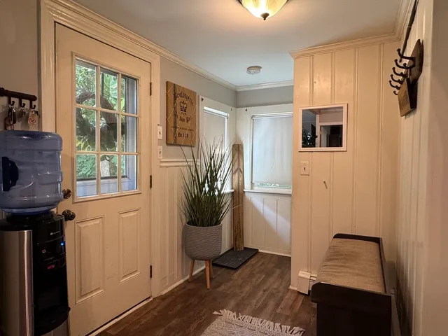 a view of a hallway with wooden floor and windows