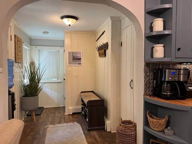 a living room with furniture and a closet