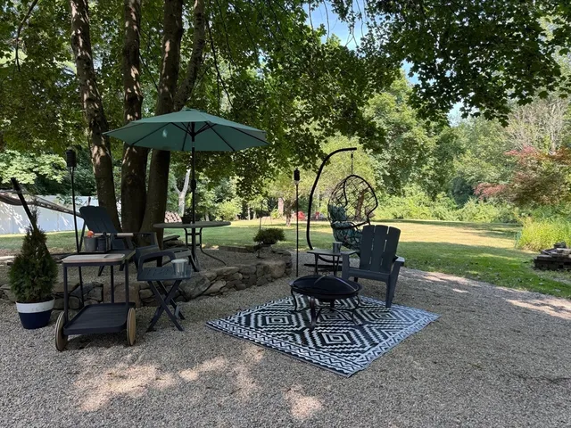 a view of a table and chairs under an umbrella