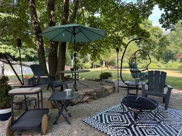 a view of a chairs and table in backyard