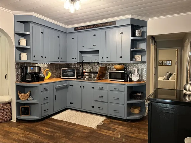 a kitchen with stainless steel appliances granite countertop a refrigerator and a stove