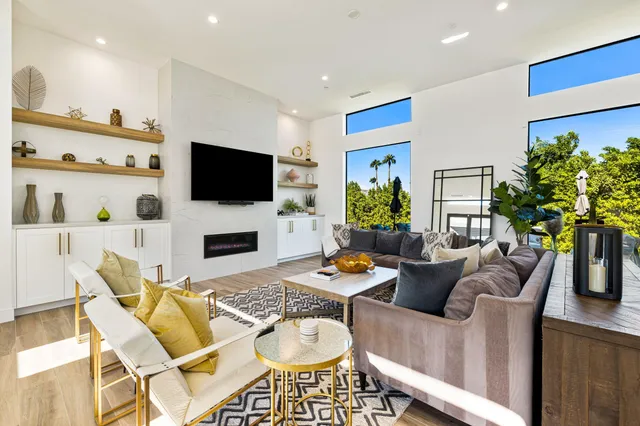 a living room with furniture a fireplace and a flat screen tv
