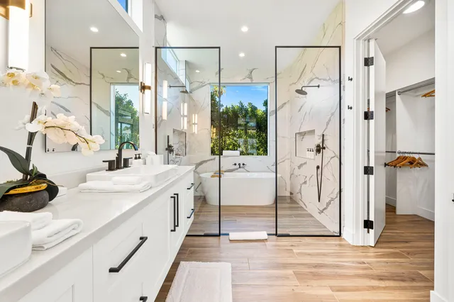 a bathroom with a double vanity sink mirror and shower