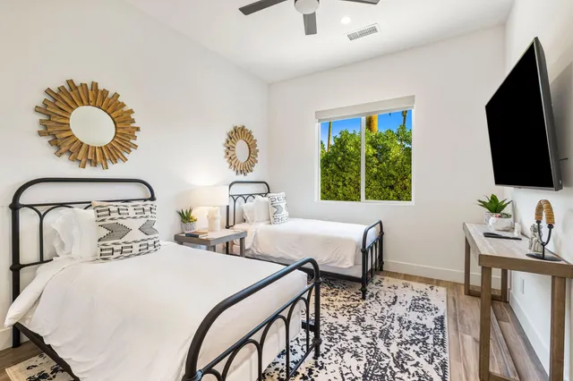 a bedroom with a bed and a flat screen tv