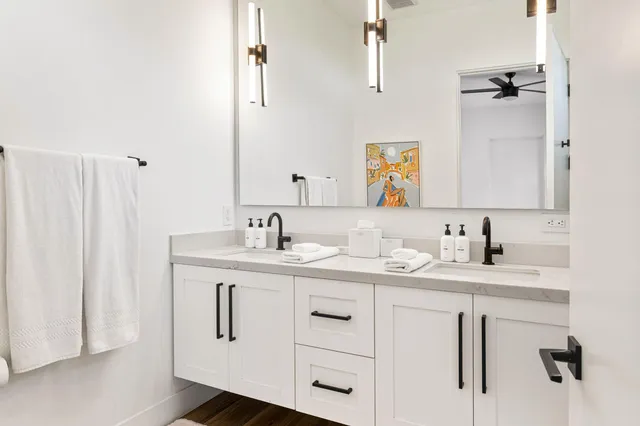 a bathroom with double sink and a mirror
