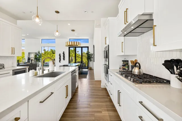 a large kitchen with stainless steel appliances lots of counter space and window