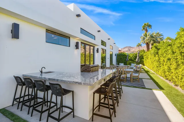 a view of a patio with table and chairs with potted plants