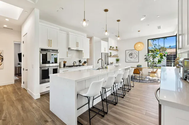 a large kitchen with a table and chairs