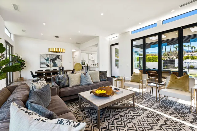 a living room with furniture and floor to ceiling window