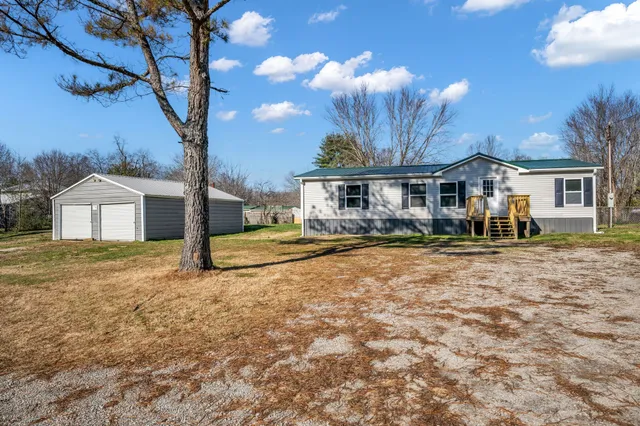 a house view with a trees in the background