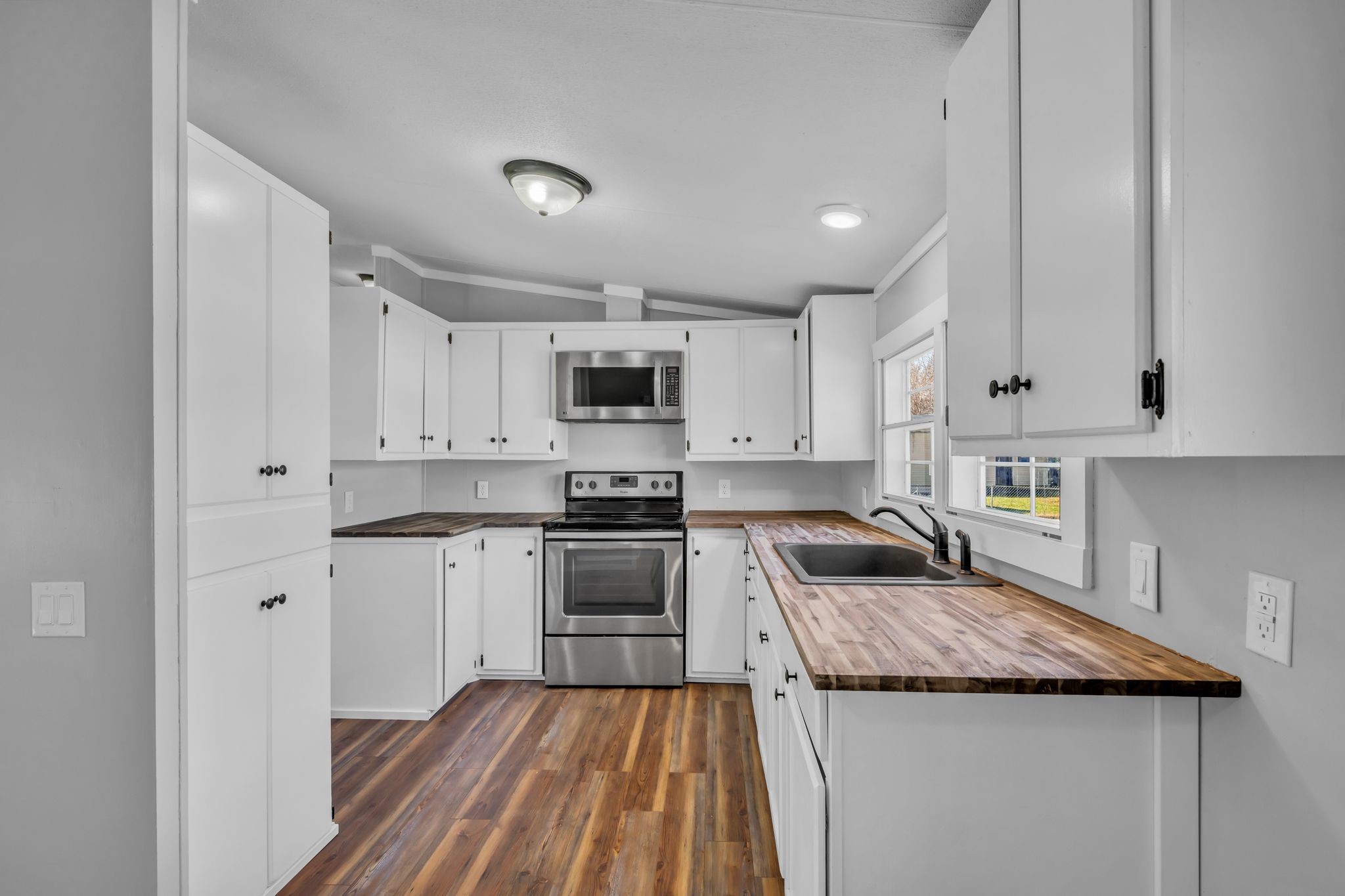 2335 Wayne Road Bon Aqua, TN 37025 - Photo 11 of 30 a kitchen with granite countertop stainless steel appliances and white cabinets