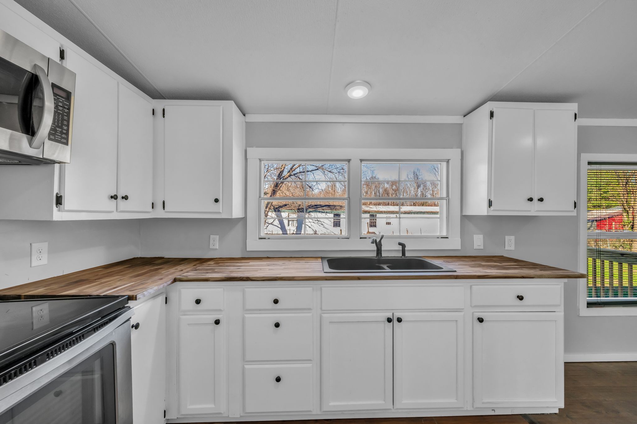2335 Wayne Road Bon Aqua, TN 37025 - Photo 13 of 30 a kitchen with granite countertop white cabinets white appliances and a sink
