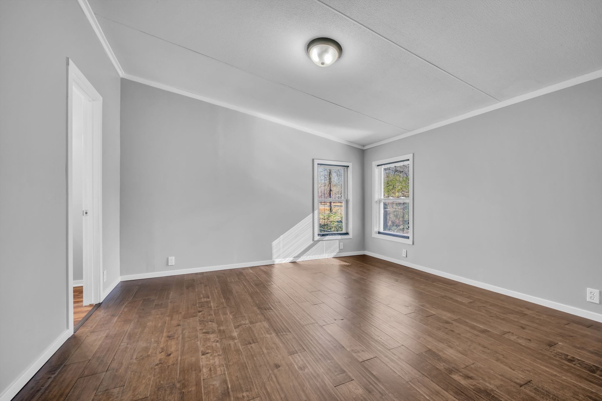 2335 Wayne Road Bon Aqua, TN 37025 - Photo 15 of 30 an empty room with wooden floor and windows