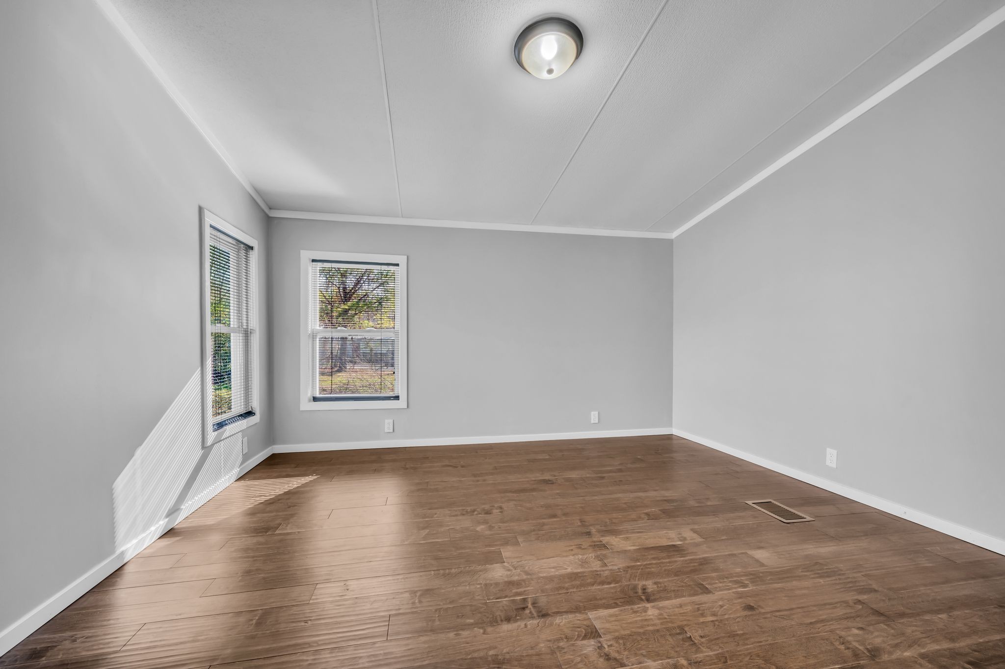 2335 Wayne Road Bon Aqua, TN 37025 - Photo 16 of 30 an empty room with wooden floor and windows