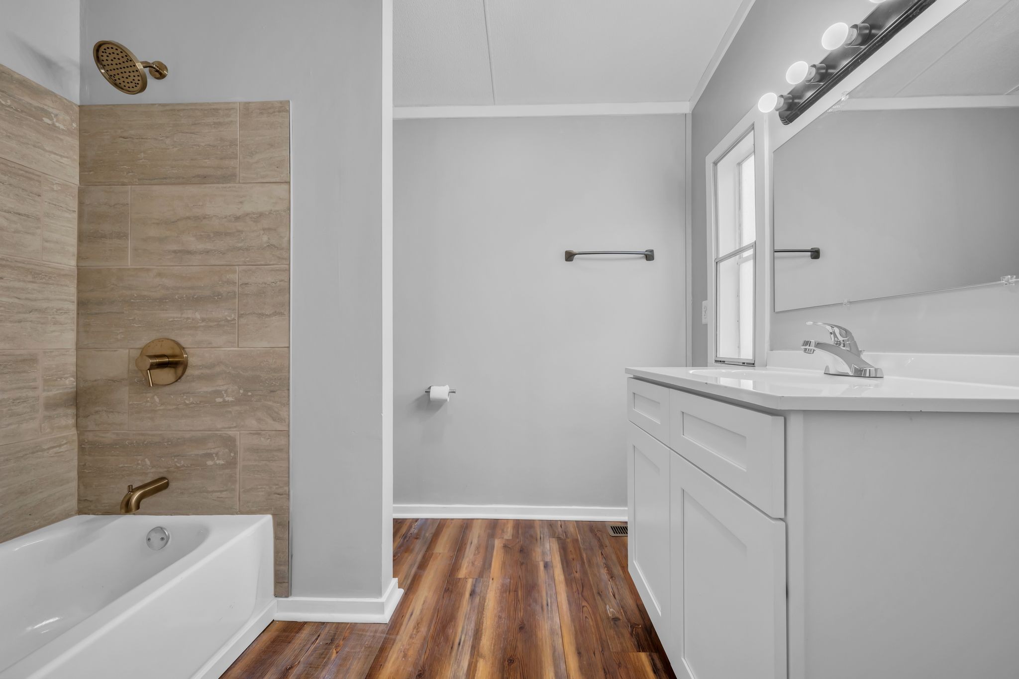2335 Wayne Road Bon Aqua, TN 37025 - Photo 18 of 30 a bathroom with a sink a mirror and a bathtub