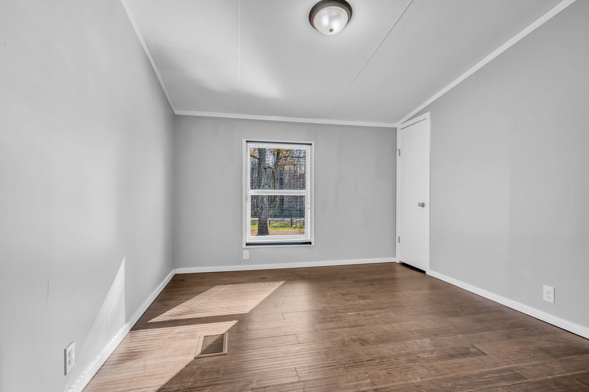 2335 Wayne Road Bon Aqua, TN 37025 - Photo 20 of 30 an empty room with wooden floor and windows