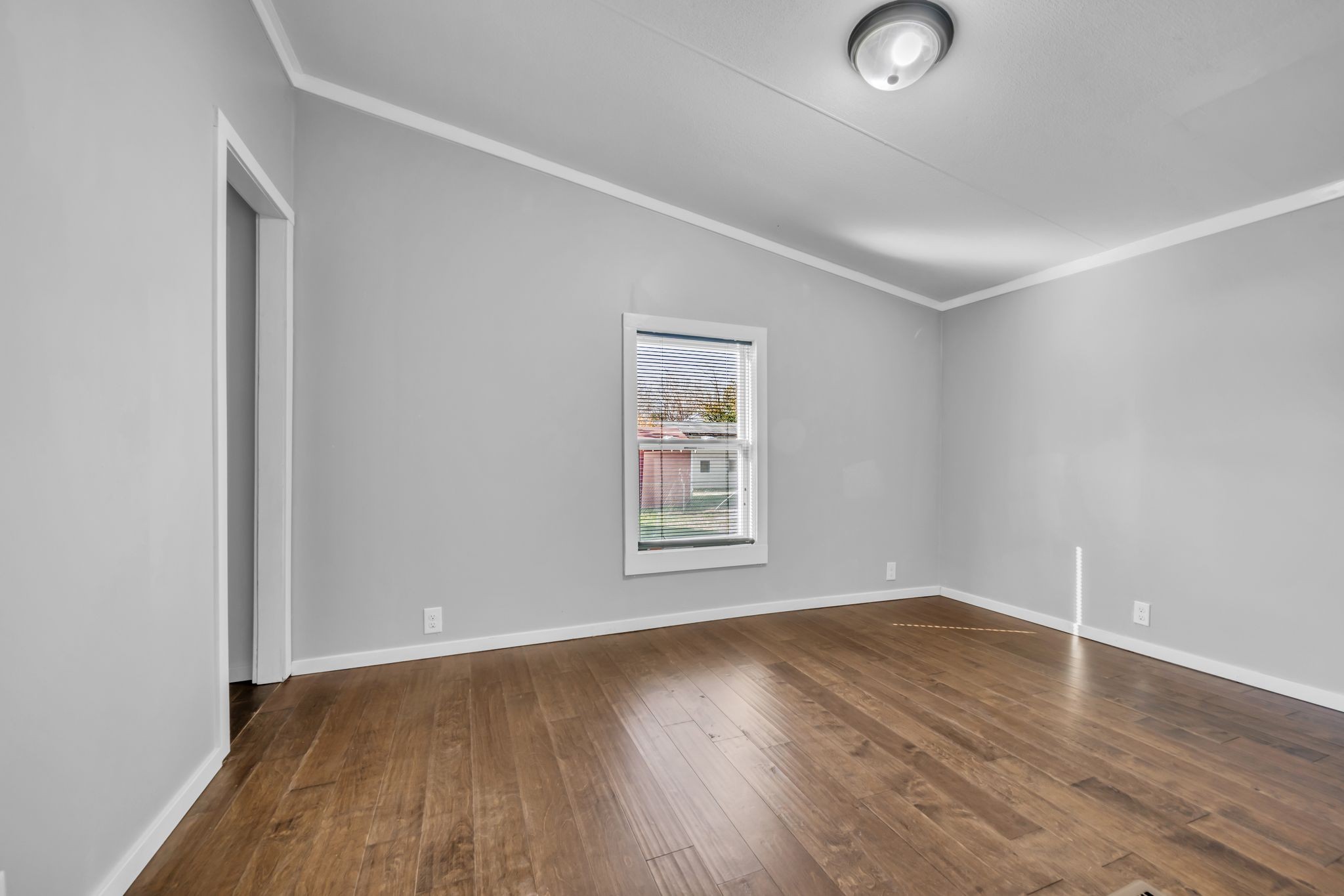 2335 Wayne Road Bon Aqua, TN 37025 - Photo 22 of 30 an empty room with wooden floor and windows