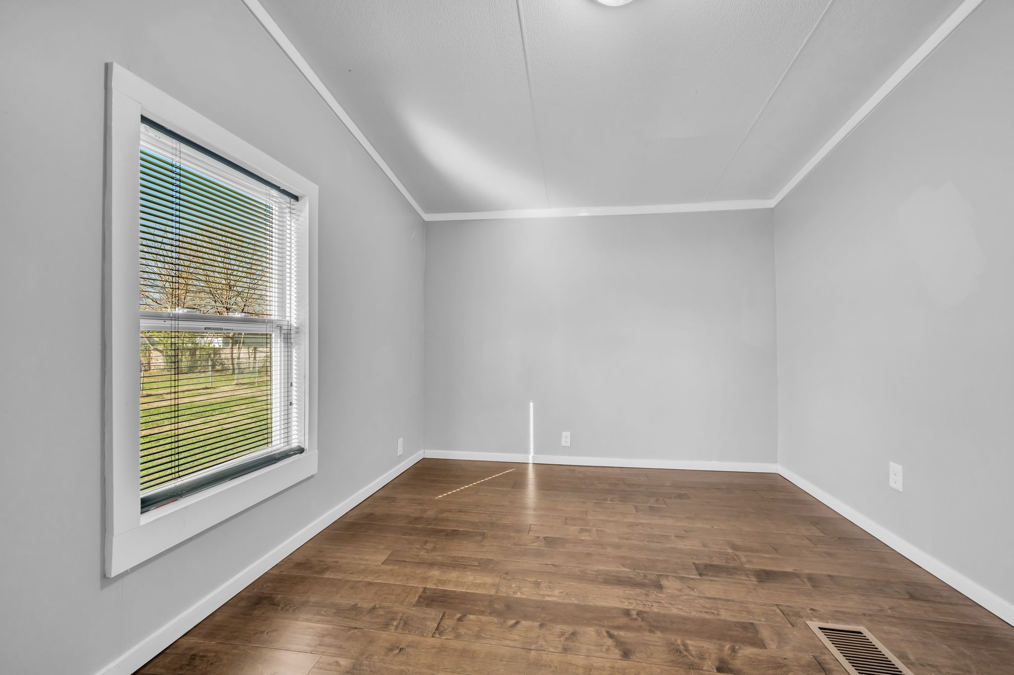 2335 Wayne Road Bon Aqua, TN 37025 - Photo 23 of 30 an empty room with wooden floor and windows