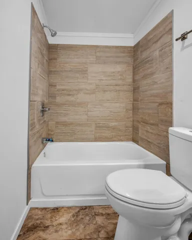 a bathroom with a toilet and a bath tub