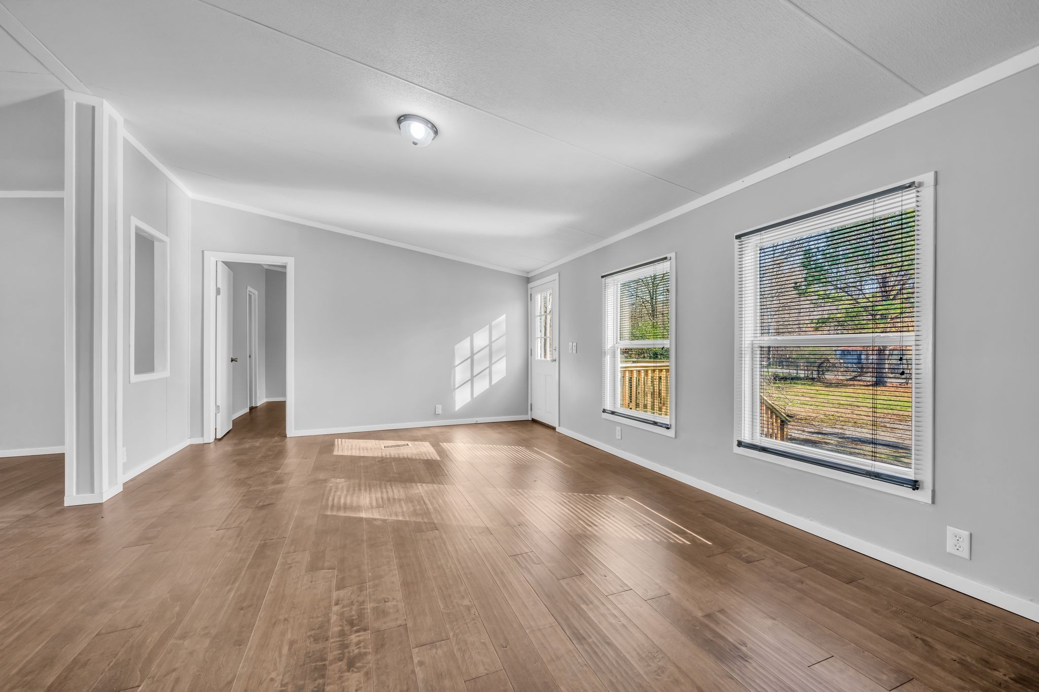 2335 Wayne Road Bon Aqua, TN 37025 - Photo 6 of 30 a view of an empty room with wooden floor and a window