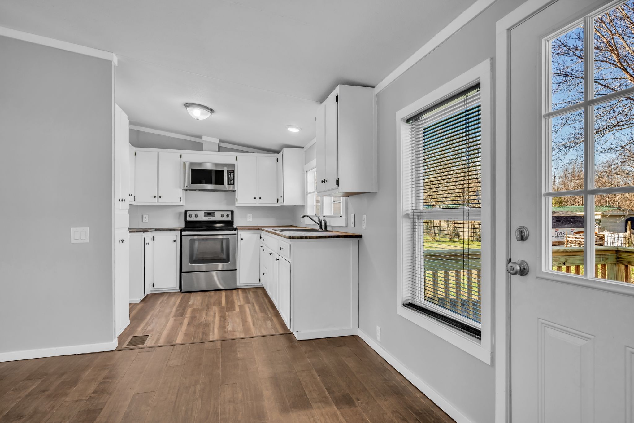 2335 Wayne Road Bon Aqua, TN 37025 - Photo 10 of 30 a kitchen with granite countertop a refrigerator and a stove top oven