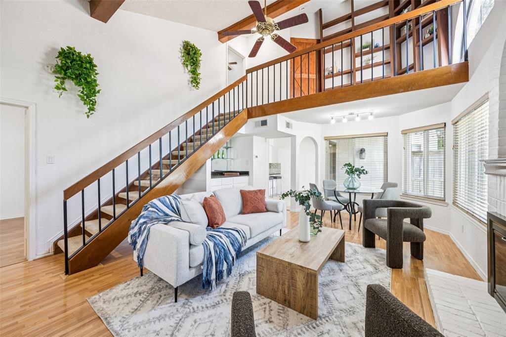 a living room with furniture or wooden floor and a potted plant