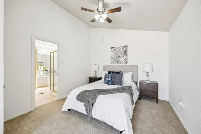 a bedroom with a bed and a painting on the wall