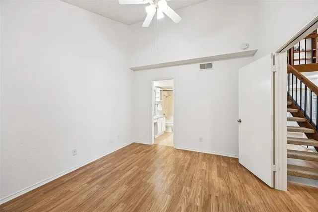 a view of a hallway with wooden floor and entryway