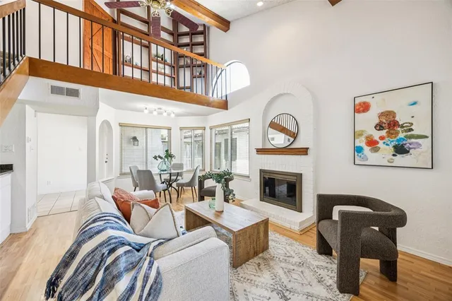 a living room with furniture a fireplace and wooden floor