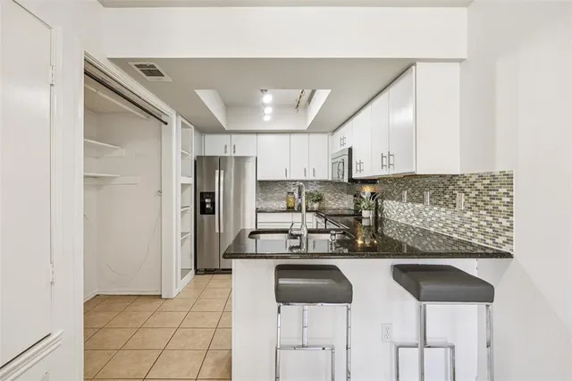 a kitchen with a sink cabinets and stainless steel appliances